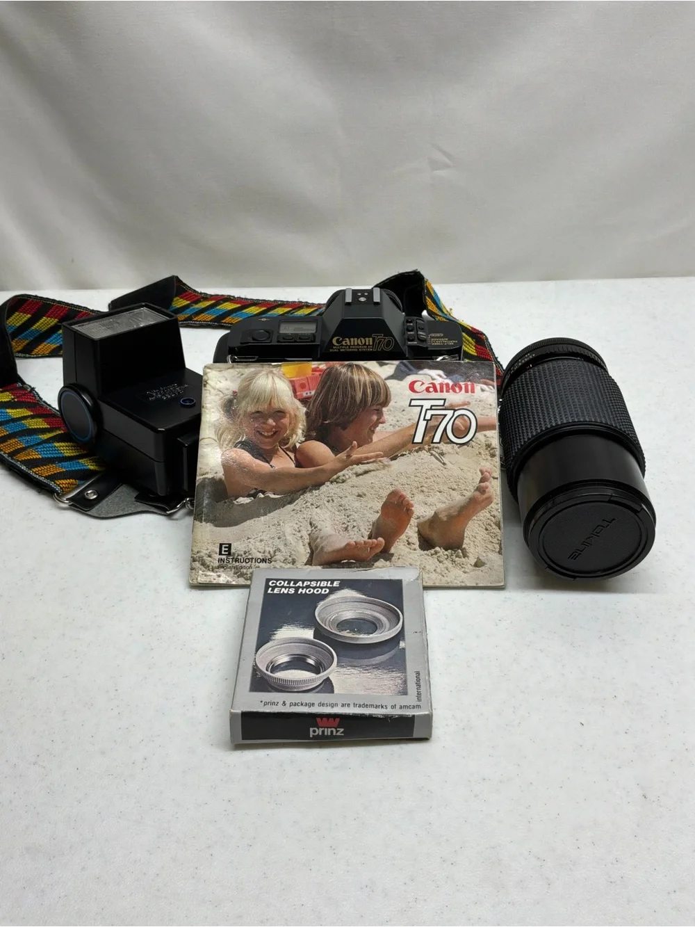 Canon T70 35mm SLR Camera with Black Telephoto Lens and Accessories